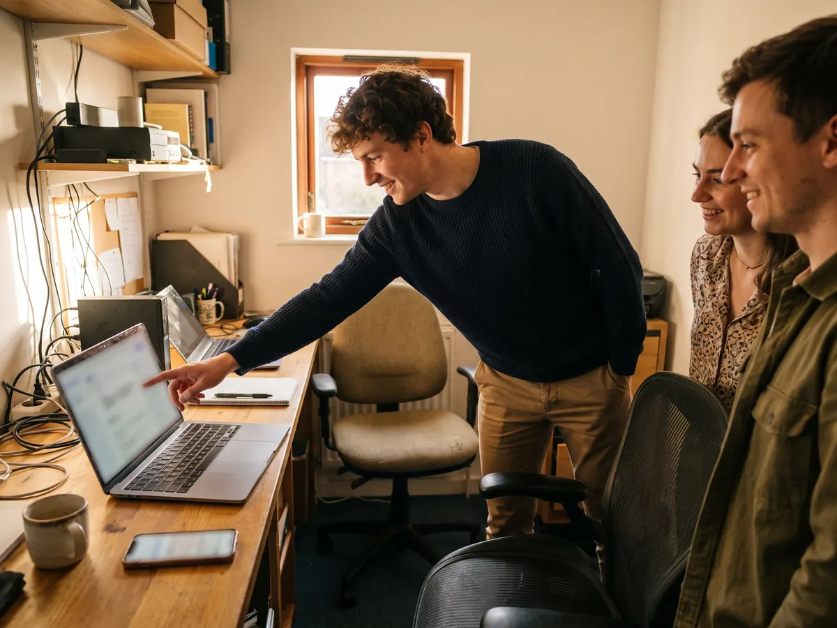 A small business owner smiling as she works away on her laptop